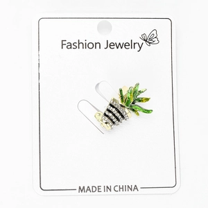 Close-up of mini cactus brooch with green enamel and white zircons on display card