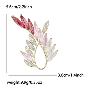 Elegant olive branch brooch with red and pink crystals and dimensions 5.6cm by 3.6cm