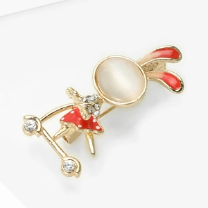 Detail of cute rabbit girl brooch with red enamel, cat eye stone and shiny rhinestones