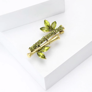 Bamboo shaped gold brooch pin with green crystals and rhinestones for women
