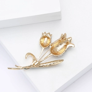 Macro shot of the back of gold tulip brooch showing security pin lock and textures