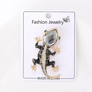 Detail of lizard brooch with black enamel, grey gemstone head and crystal spinal inlay