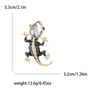 Vintage lizard brooch with grey crystal and black enamel detail on gold metal base