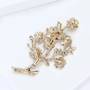 Macro view of the gold-plated metal brooch back with long safety pin fastening