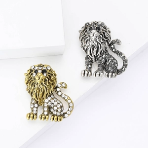 Vintage lion brooch in gold and silver alloys with rhinestones for elegant suit decoration