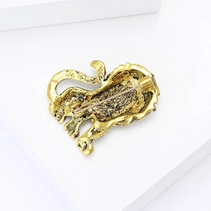 Detailed back view of vintage lion brooch showing textured alloy finish and safety pin