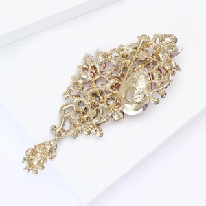 Detail view of the intricate gold alloy back and pin fastener of this crystal brooch