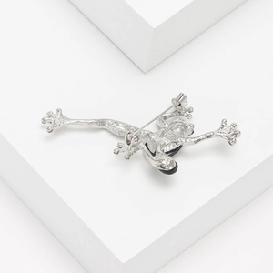 Silver frog brooch back view showing metal texture and secure safety pin clasp