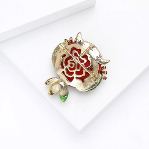 Detailed back view of a red flower brooch with gold plating and secure pin closure