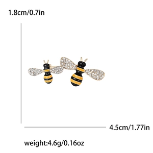 Cute enamel bee brooch set with rhinestones and black yellow wings on white background