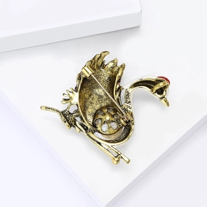 Detailed back view of vintage swan brooch with gold plating and classic pin clasp closure