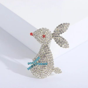 Elegant rabbit brooch with white and red rhinestones on a minimalist white platform
