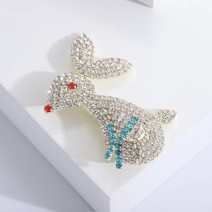 Detailed close-up of sparkling full crystal rabbit brooch with blue stone accents