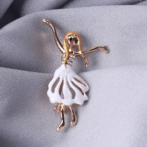Elegant gold ballerina brooch with white enamel skirt and sparkling crystal accents