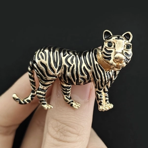 Macro shot of gold and black tiger brooch badge with detailed vintage alloy enamel craft