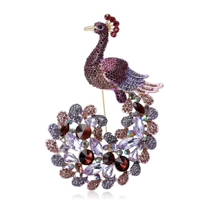 Exquisite peacock brooch with multi-color rhinestones and crystals on white background