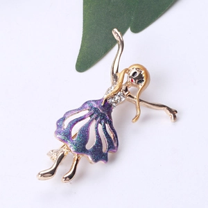 Detailed close-up of a gold ballet dancer brooch with sparkling purple glitter skirt detail