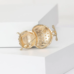 Back view of a gold-plated owl brooch featuring a secure metal safety pin and matte finish
