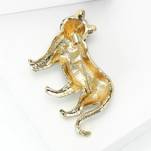 Golden vintage tiger brooch with textured back and secure pin buckle on white background