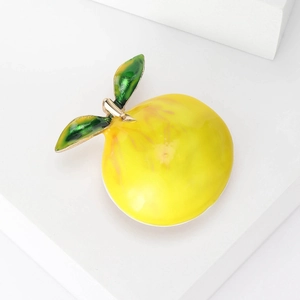 Fashionable lemon fruit brooch in yellow enamel with gold metal and green leaves