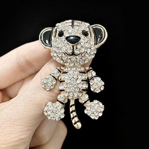 Detail of tiger brooch with gold alloy base and sparkling rhinestones on black background