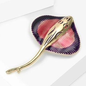 Detailed macro shot of stingray brooch with purple gradient enamel and golden alloy finish