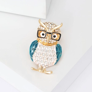 Elegant owl brooch with sparkling rhinestones and green enamel wings in gold-tone metal