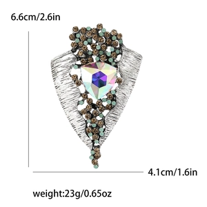Detailed view of vintage alloy brooch with rhinestones and iridescent triangle gem
