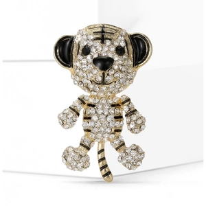 Macro detail of cute tiger brooch with sparkling rhinestones and black enamel accents
