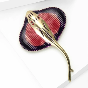 Macro view of gradient enamel manta ray brooch with golden alloy and fine textures