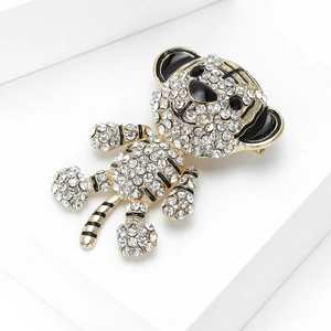 Macro detail of a crystal-encrusted tiger brooch with black enamel on a gold metal base
