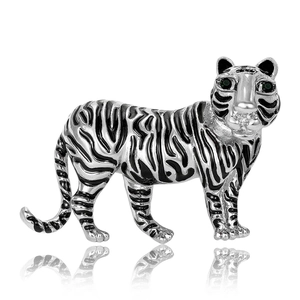 Vintage silver tiger brooch with black enamel stripes and green gemstone eyes