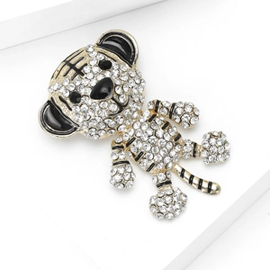 Detailed view of a gold-plated tiger brooch featuring sparkling rhinestones and black enamel