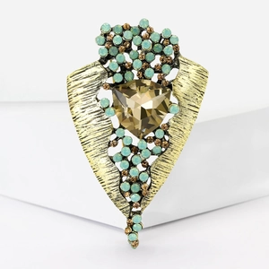Detail of vintage luxury brooch with amber glass stone and light blue rhinestones
