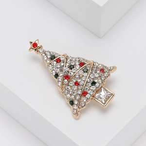 Broche sapin de Noël tendance avec strass colorés sur un support blanc minimaliste