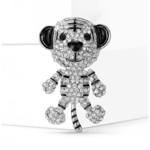 Close-up of a silver tiger brooch with sparkling white rhinestones and black enamel details