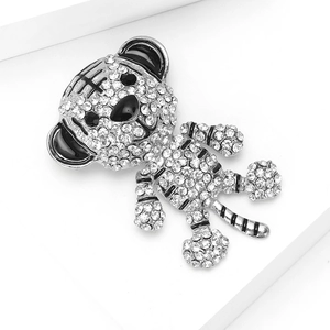 Macro detail of a cute tiger brooch featuring sparkling rhinestones and black enamel accents
