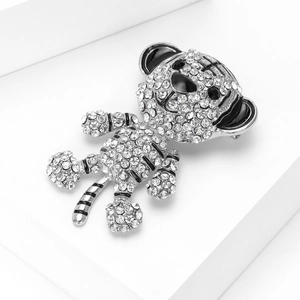 Detailed view of a silver tiger brooch with sparkling rhinestones and black enamel accents