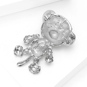 Detail view of the silver bear brooch back showing the sturdy metal pin clasp and texture