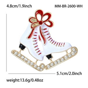 Enamel ice skate brooch with red bow and rhinestones, sized 4.8cm by 5.1cm
