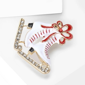 Elegant enamel ice skate brooch with red ribbon bow and rhinestones on a white stand