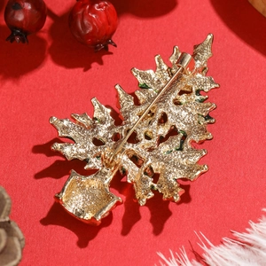 Back view of gold-tone Christmas tree brooch with secure pin clasp and green enamel edges
