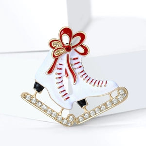 Exquisite white enamel ice skate brooch with a red bow and sparkling rhinestones on base