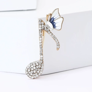Élégante broche note de musique dorée avec strass scintillants et accent papillon bleu