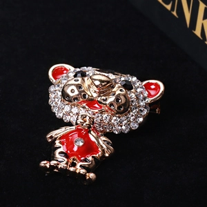 Macro shot of cute cartoon tiger brooch with red enamel and sparkling crystal details