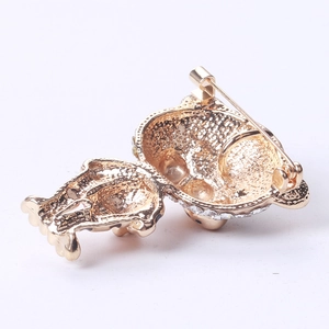Detailed back view of a gold tiger brooch featuring a secure pin clasp and inlaid crystals