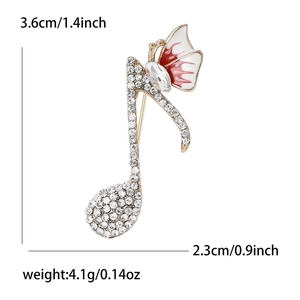 Broche note de musique et ailes en émail rouge blanc et strass de 3,6x2,3cm