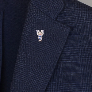 Cute cartoon tiger brooch pin with sparkling blue crystals on a navy plaid blazer lapel