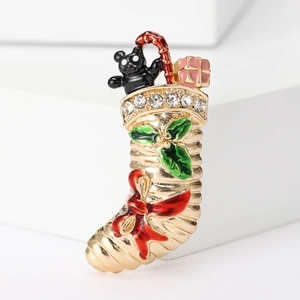 Detailed macro shot of a Christmas stocking brooch with crystal accents and enamel finish
