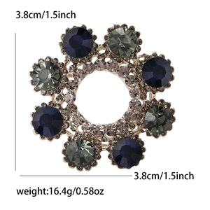 Detail view of wreath brooch with dark blue and gray crystals showing 3.8cm diameter size
